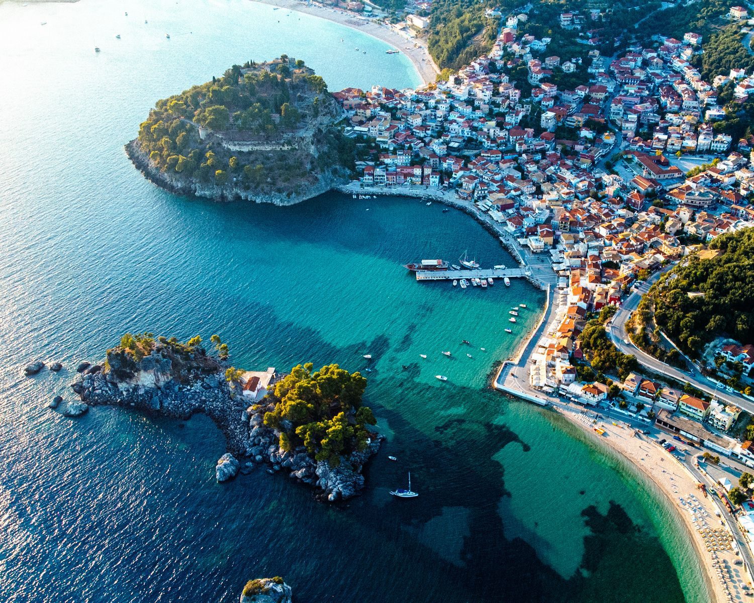 Stunning aerial view of Parga's vibrant coast, showcasing its turquoise waters and charming town.
