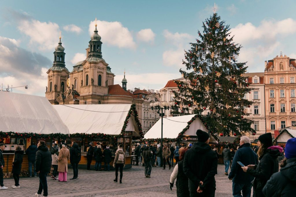 a crowd of people standing around a christmas tree