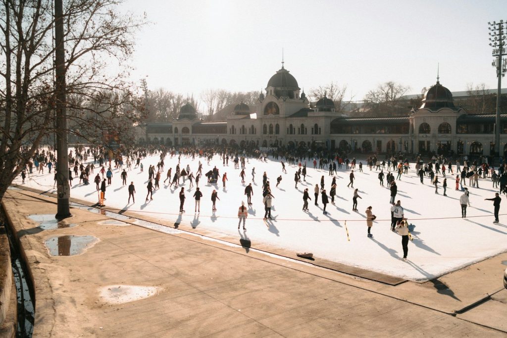 A large group of people skating on an ice rink