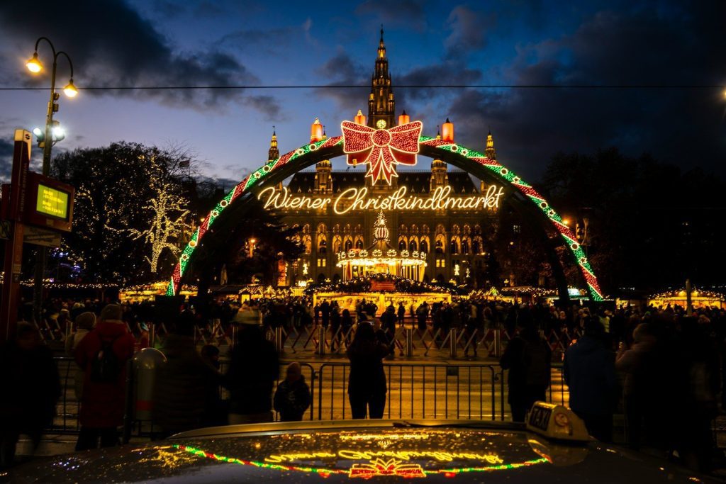 Christmas market archway with illuminated building at night